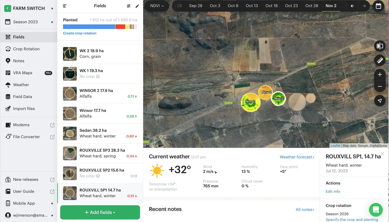 FarmSwitch field monitoring view: a satellite basemap with NDVI-coloured field boundaries, a planted-hectare total, and a list of fields with crop type and current index values.
